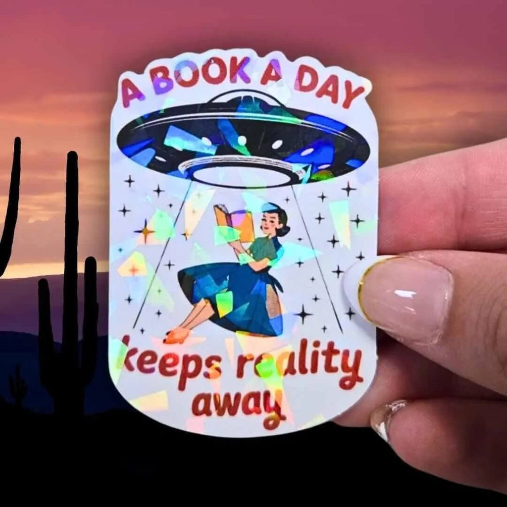 A Book A Day Keeps Reality Away – Holographic Book Lover Sticker, Alien UFO Abduction Reading Sticker, Bookish Sticker, Sci - Fi Reader Gift - Holographic Sticker | The TabbyLoaf