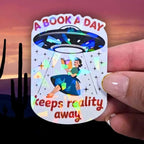 A Book A Day Keeps Reality Away – Holographic Book Lover Sticker, Alien UFO Abduction Reading Sticker, Bookish Sticker, Sci - Fi Reader Gift - Holographic Sticker | The TabbyLoaf