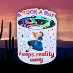 A Book A Day Keeps Reality Away – Holographic Book Lover Sticker, Alien UFO Abduction Reading Sticker, Bookish Sticker, Sci - Fi Reader Gift - Holographic Sticker | The TabbyLoaf