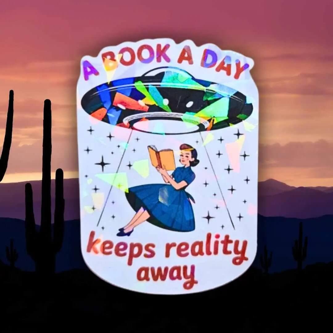 A Book A Day Keeps Reality Away – Holographic Book Lover Sticker, Alien UFO Abduction Reading Sticker, Bookish Sticker, Sci - Fi Reader Gift - Holographic Sticker | The TabbyLoaf