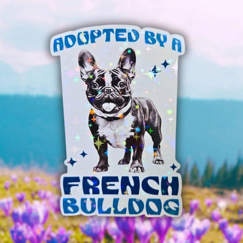 Star Rainbow holographic French Bulldog sticker with ‘Adopted By A French Bulldog’ text — funny dog lover design for laptops and journals.