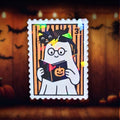 Gem holographic bookish ghost sticker with glasses reading pumpkin book, black cat on head, cozy spooky aesthetic for books and laptops