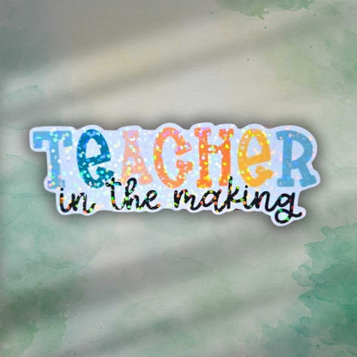Teacher in the making holographic sticker
Teacher gift
education teacher gift

Celebrate the journey of becoming a teacher with this vibrant holographic vinyl sticker! Perfect for student teachers, education majors, or anyone working toward their teaching career. With its eye-catching sparkle and motivational design, this sticker makes a thoughtful little gift for graduations, first days of student teaching, or just a boost of encouragement perfect for laptops, water bottles notebooks clipboards