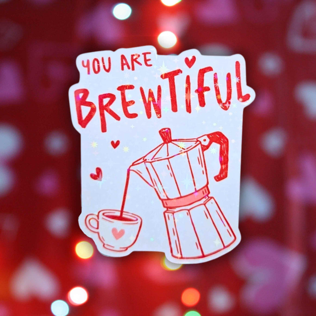 Add some spark and shine to your everyday essentials with the "You Are Brewtiful" holographic sticker! This waterproof vinyl decal features a playful coffee pun combined with an adorable coffee cup and moka pot illustrations making it a perfect gift for coffee lovers, Valentine's Day, or just because. Whether you're decorating your laptop, water bottle, planner, or gifting, this eye-catching holo sticker will bring a touch of fun, love, and personality to any surface. Fade resi