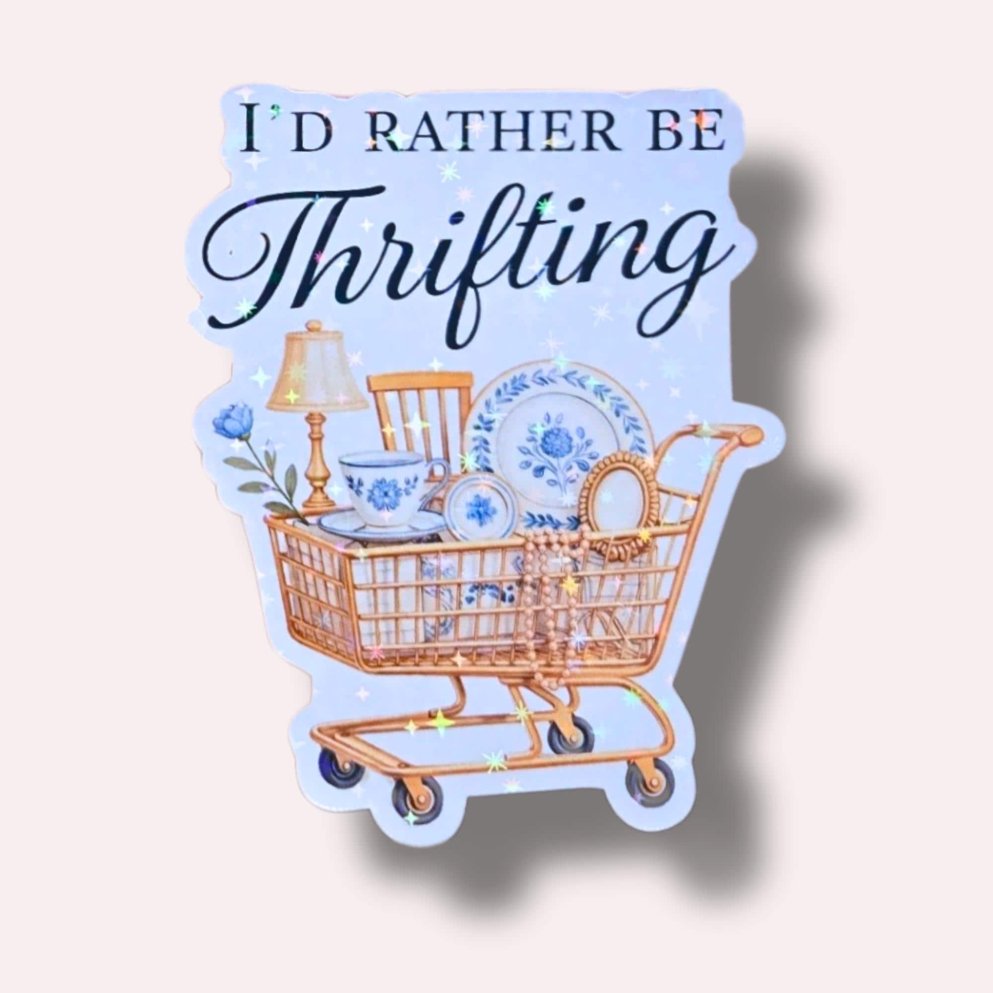 Star holographic I’d Rather Be Thrifting sticker with vintage shopping cart and blue china — cozy nostalgic design for eco and vintage style lovers.