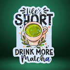Star holographic Life’s Short Drink More Matcha sticker with green tea cup, floral and sparkle details, cozy tea lover design for journals and tumblers